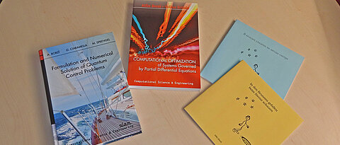 Books on a table (published by Prof. Dr. Alfio Borzi)