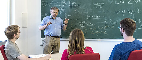 Professor Klingenberg teaches in front of a blackboard