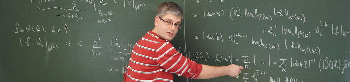 Professor Wachsmuth is writing on a blackboard