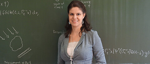 Prof. Dr. Bernadette Hahn in front of a blackboard